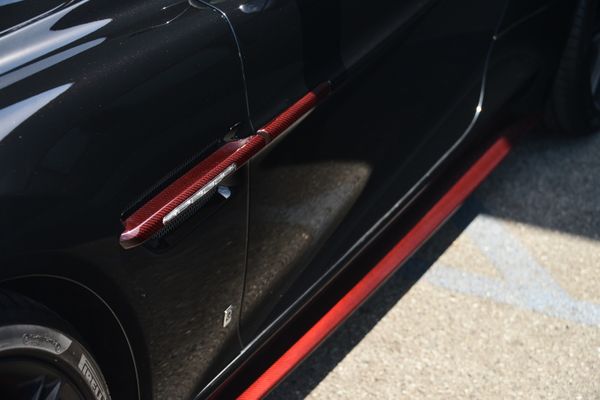 Black and red 2015 Aston Martin Vanquish Q Collection for sale by Sandbox Motors.